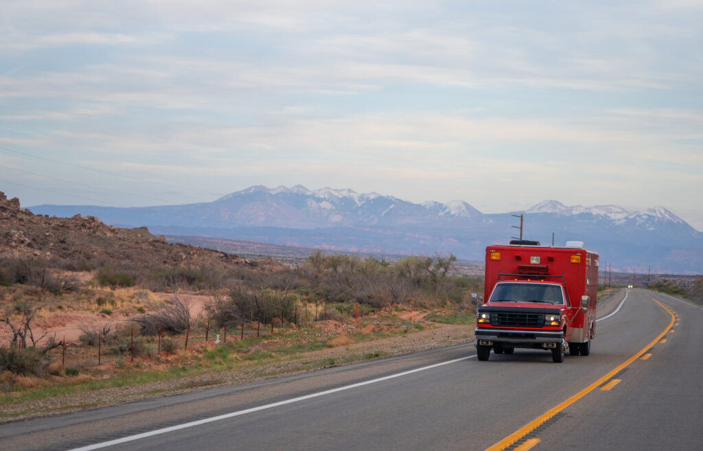 Ambulance emergency truck vehicle speeding in double line road in Utah, USA